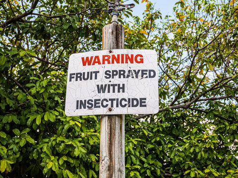 BRISBANE, AUSTRALIA - SEPTEMBER 27, 2012: Warning sign stating fruit sprayed with insecticide at Brisbane Botanic Gardens Mt Coot-tha