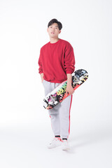 Young Man Holding Skateboard on White Background © HuaThuy