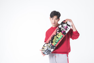 Young man holding skateboard on white background © HuaThuy