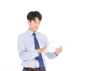 Smiling businessman using tablet isolated on white © LaDieuNgoc