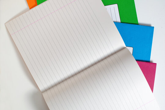 Open Lined Notebook on Colored Cover Stack