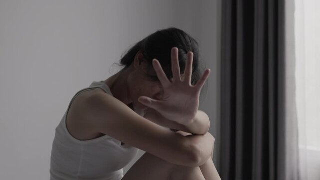 Woman raising her hand to stop abuse, standing against domestic harm and family conflict while seeking safety, protection and support.
