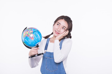 Fototapeta premium Thoughtful young woman holding a globe on white background