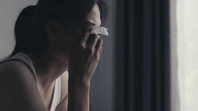 Depressed woman crying with tears, expressing sadness, anxiety and emotional trauma from abuse, family conflict and difficult life circumstances.