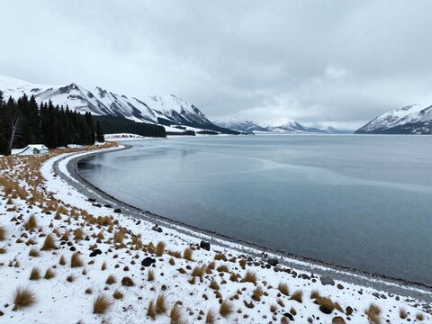 Aerial Light Snow On Lakeshore Grass Lake Tekapo Winter August NZ