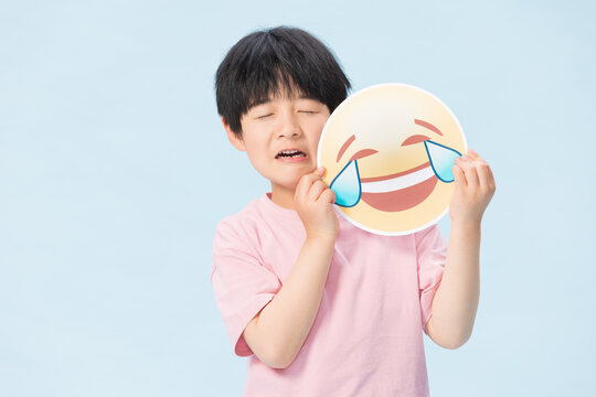 Boy Holding Laughing Crying Emoji Face