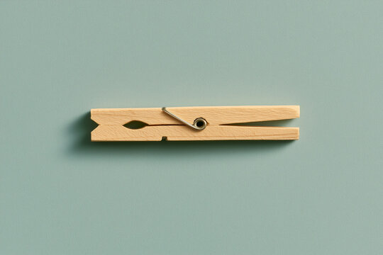 Single wooden clothespin on a pastel surface minimal everyday concept