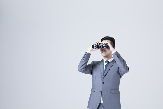 Businessman Looking Ahead with Binoculars