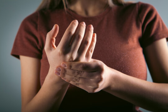 Close-up of a woman suffering from finger pain