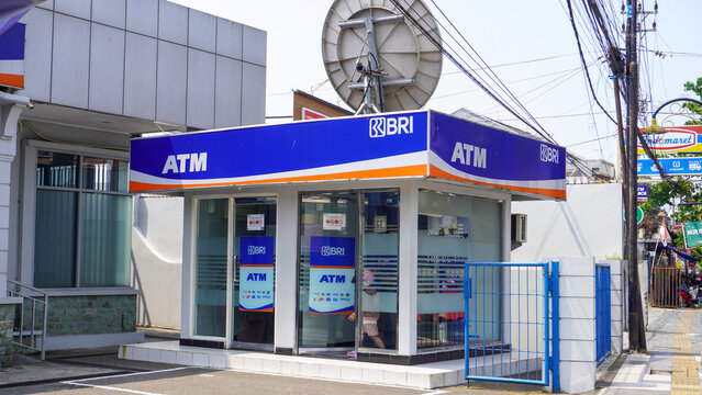 Exterior view of Bank Rakyat Indonesia (BRI) outdoor ATM booth building on a sunny day. Public financial banking services for cash withdrawal in Yogyakarta, Indonesia.