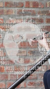 Animation of globe and binary coding over caucasian woman talking on smartphone