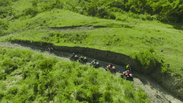 4K Drone Aerial View of Tourists Riding ATVs Near Mayon Volcano Philippines. exciting off-road adventures, lush green countryside, and tropical coconut palm groves