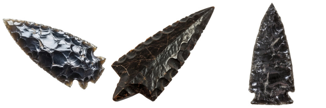 Three obsidian arrowheads, ancient tools, isolated on white background