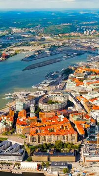 Vertical video. Gothenburg, Sweden. River Gota Alv and Rosenlund Canal. Panoramic view of the central part of the city. Summer day. Cloudy weather. Drone footage, Point of interest. Rich colors