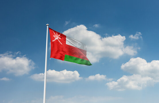 Oman flag waving in beautiful sky.