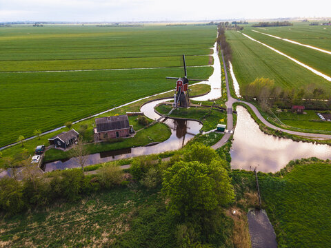 Classic Dutch windmill in the green countryside from above