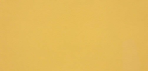 Fototapeta premium Yellow wall texture background with grainy paint surface