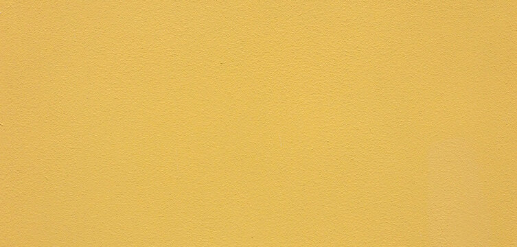 Yellow wall texture background with grainy paint surface