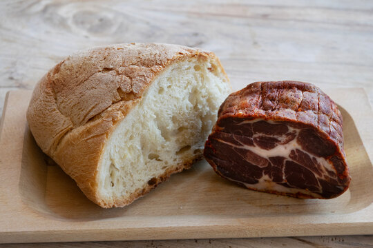 rustic bread cured meat capocollo wooden board