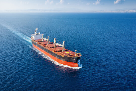 Aerial view of a large general cargo bulk carrier ship sailing over the ocean