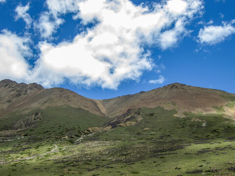 Breathtaking mountain landscape under a clear blue sky with scattered clouds