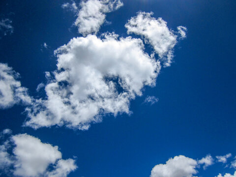 Bright blue sky with fluffy white cumulus clouds