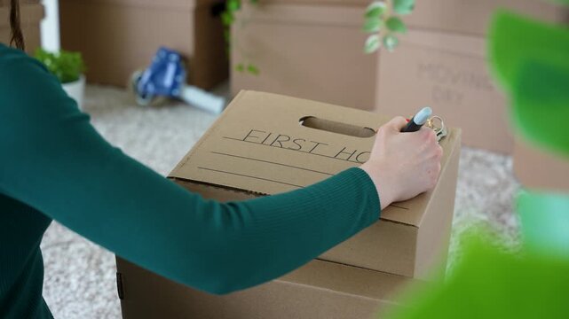 Woman Labeling Moving Box as First Home Relocating Canada