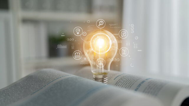 Light bulb on open book symbolizing knowledge, ideas, innovation, creativity, and technology in modern learning environment with digital elements. Entropy.