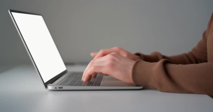Student typing on modern silver laptop for remote education study purpose