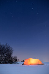 Illuminated tent under a clear sky in winter © Alexander Erdbeer