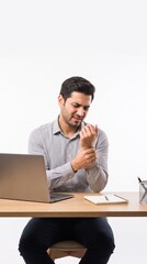 Fototapeta premium Young Man Suffering From Wrist Pain While Working On Laptop, Experiencing Discomfort And Strain