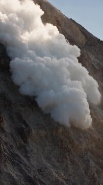 Volcano releasing steam from its peak
