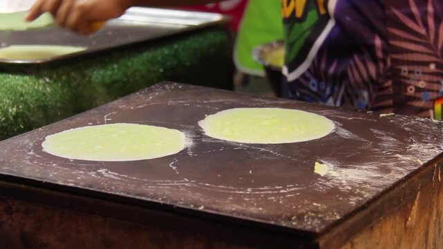 Traditional Thai cotton candy roti with sweet floss wrapped in soft dough, street snack.