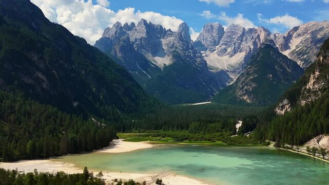 serene mountain range with a lake, aerial view of rocky terrain and scenic water body, travel and nature landscape, blue and green hues, majestic and peaceful scene, high vantage point, v2a.