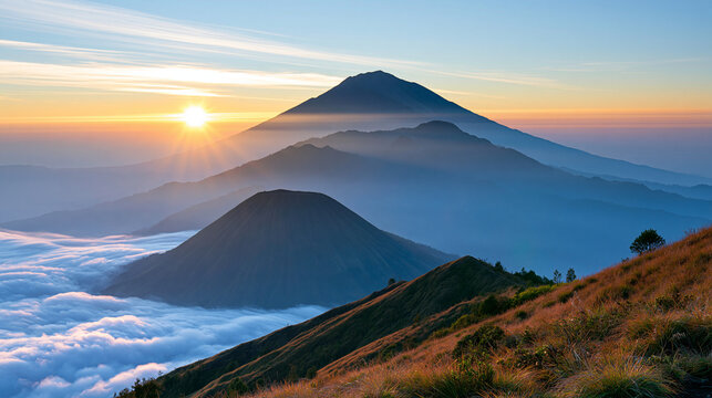 Dramatic volcanic mountain landscape during sunset, distant glowing volcanic haze, layered mountains and atmospheric clouds, powerful natural phenomenon, wilderness travel