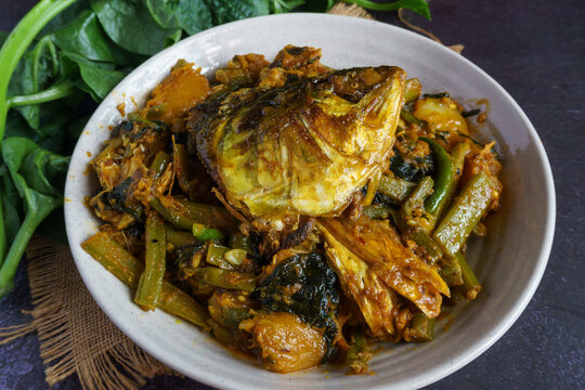 Ilish Macher Matha Diye Pui Shaker Ghonto Traditional Bengali Hilsa Fish Head with Malabar Spinach Curry Served in a Bowl