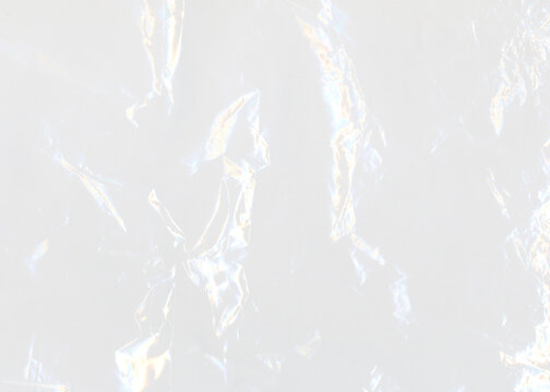 Сrumpled aluminum foil. Plastic transparent cellophane background. Natural plastic texture surface.	