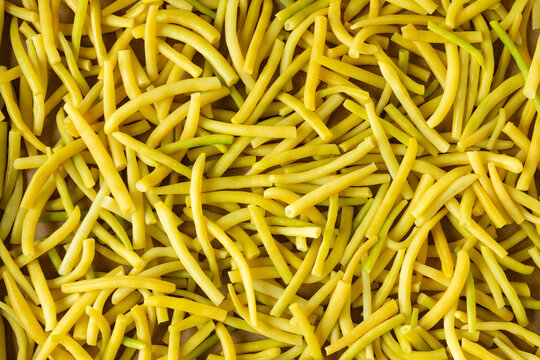 Preparing green beans (Golden Teepee variety) for freezing. The sliced ​​and blanched pods are dried before being frozen. Background texture.