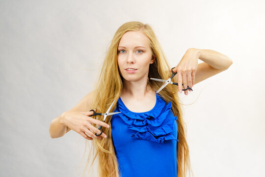 Girl with scissors for haircutting