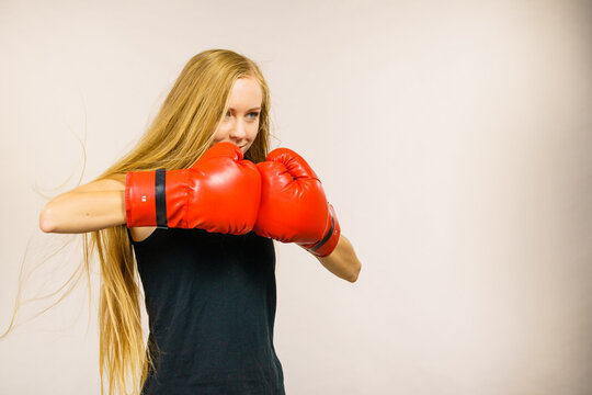 Woman in gloves playing sports boxing