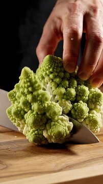 Cutting romanesco cauliflower in a kitchen while preparing for a meal
