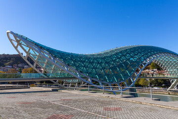 Modern glass Bridge of Peace across the Kura River in Tbilisi, Georgia © Pavel