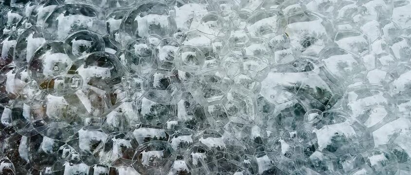 Close-up view of oxygen bubbles rising through water in a fish tank, creating aeration and surface movement. Freshwater aquarium background for aquatic life, fish care, and water quality.