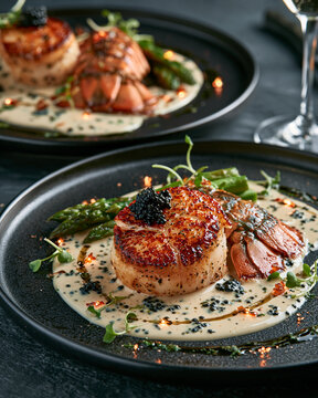 Luxury lobster medallions with black caviar, champagne beurre blanc, asparagus tips and microgreens, refined black porcelain plate, ultra elegant haute cuisine presentation