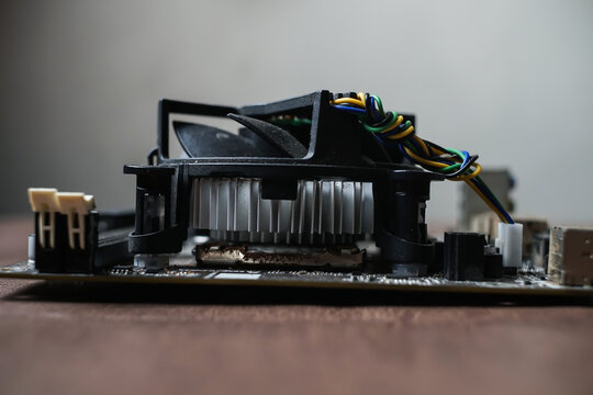 Computer motherboard with cooling fan on fabric background