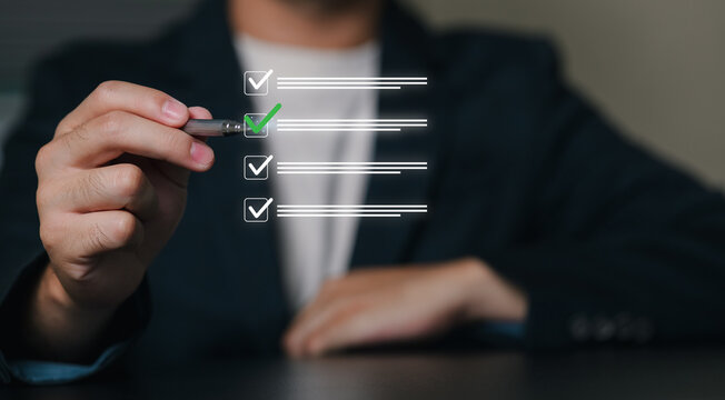A business professional in formal attire interacts with a transparent digital checklist interface, representing productivity, organization, and task management.