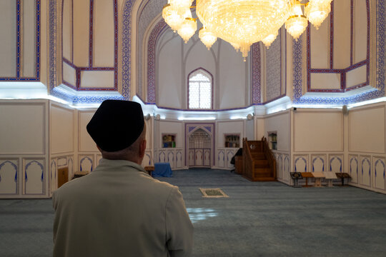 Man Praying Mosque Interior Mihrab Minbar Carpet

