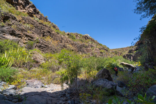 Hiker photographing a volcanic ravine