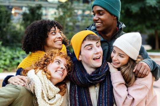 Diverse young group of millennial friends having fun together on winter vacation. Friendship and holiday lifestyle concept