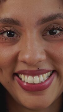 Close up portrait of smiling young African American pretty woman. Front view headshot of Brazilian female at home. Natural beauty and friendly expression. Confidence people concept. Vertical HD video